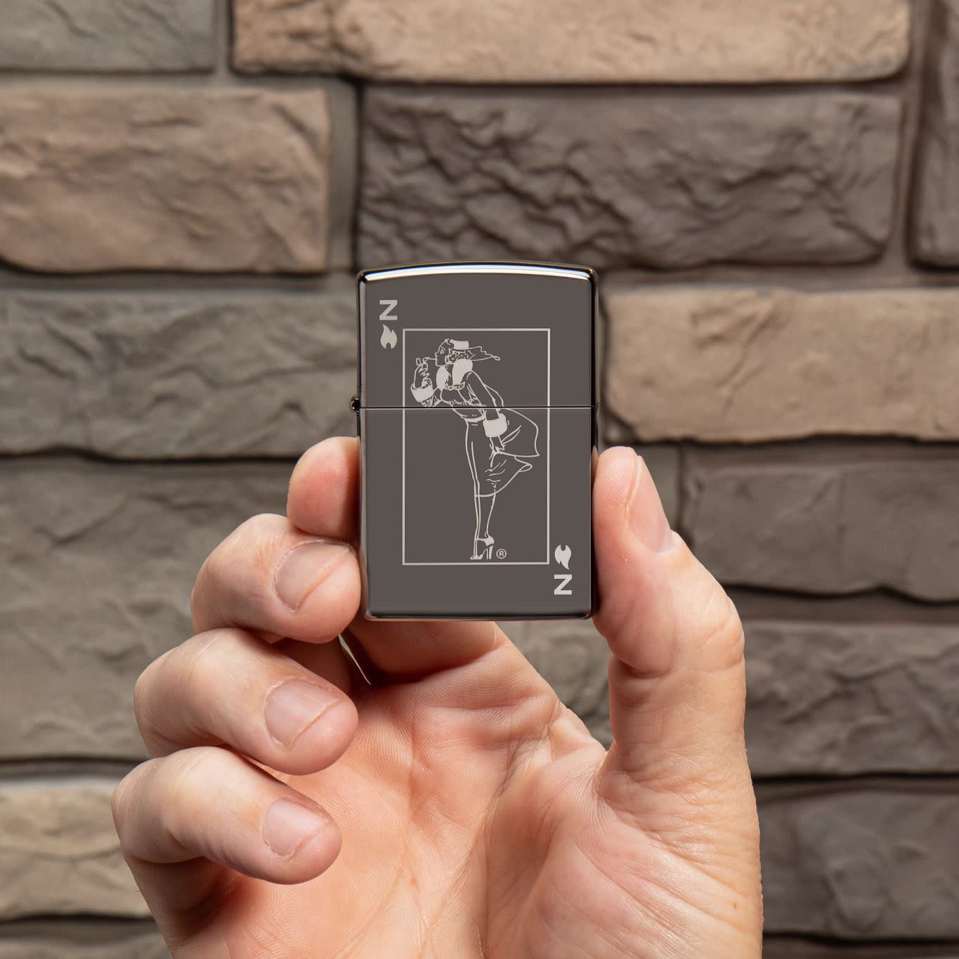 Lifestyle image of Windy Design Card Black Ice?? Windproof Lighter in hand.