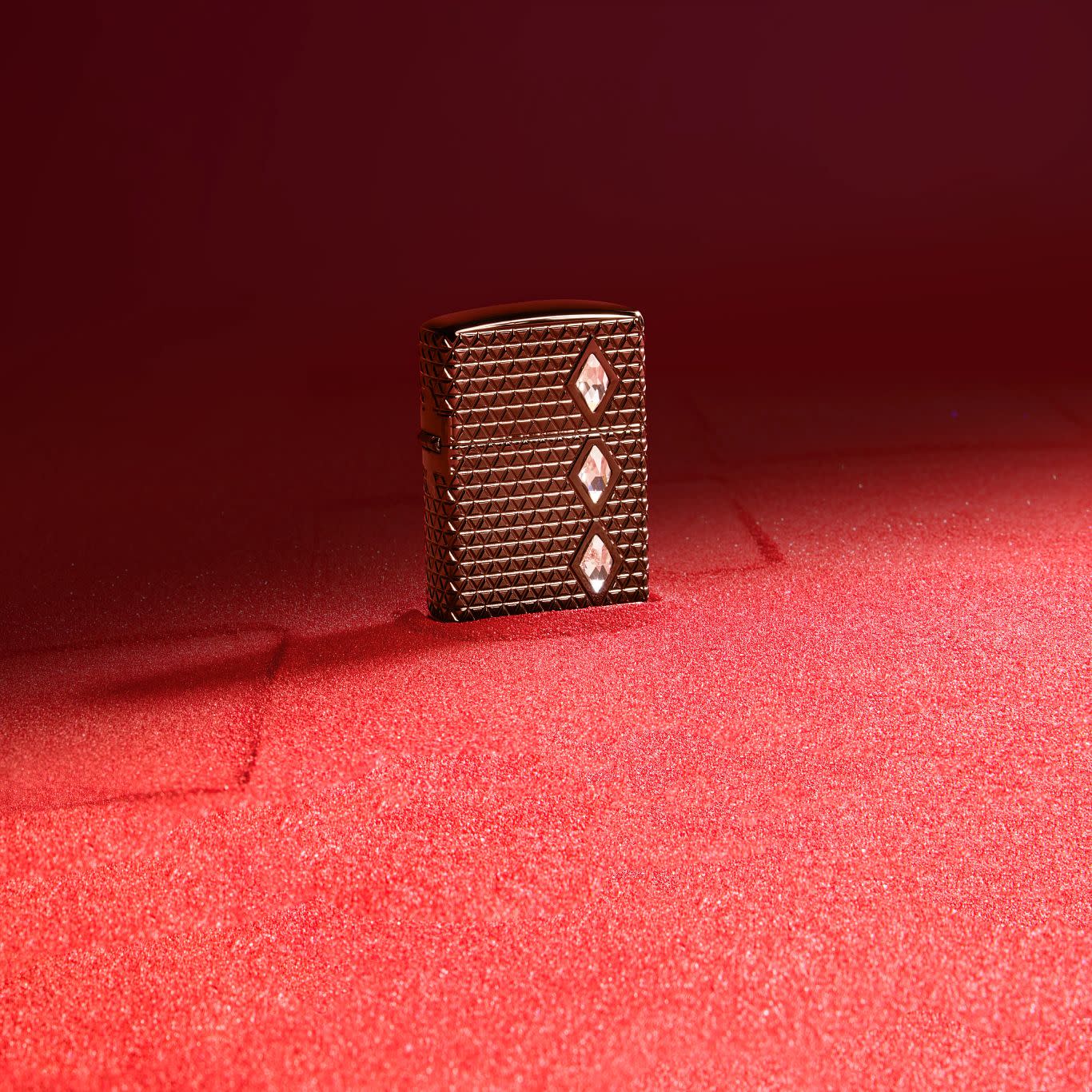 Lifestyle image of Zippo Diamond Pattern Design Armor?? Black Ice?? Windproof Lighter standing on red sand.