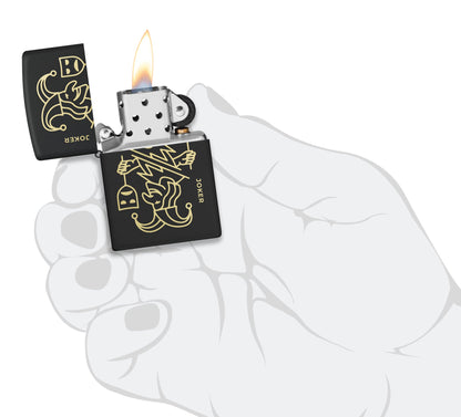 Zippo Masked Joker Design Black Matte Windproof Lighter lit in hand.