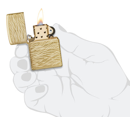 Zippo Luxury Waves Design Armor Tumbled Brass Windproof Lighter lit in hand.