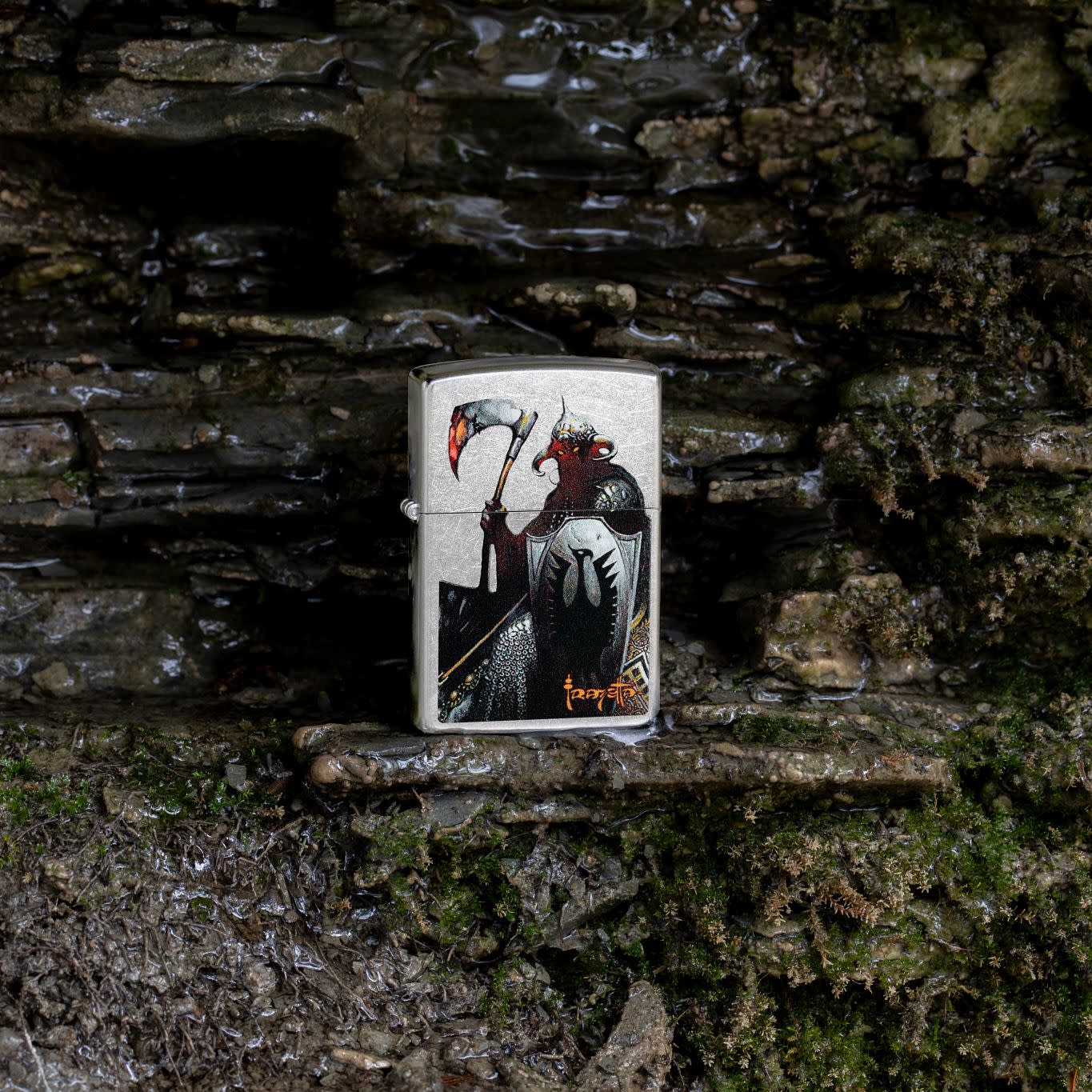 Lifestyle image of Zippo Frank Frazetta Death Dealer Street Chrome Windproof Lighter on a rocky background.