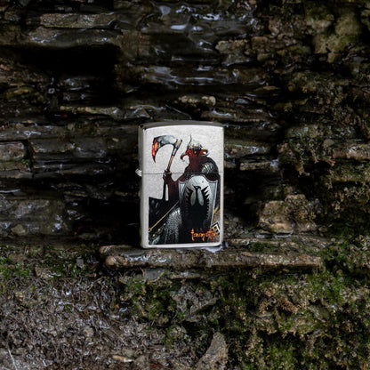 Lifestyle image of Zippo Frank Frazetta Death Dealer Street Chrome Windproof Lighter on a rocky background.