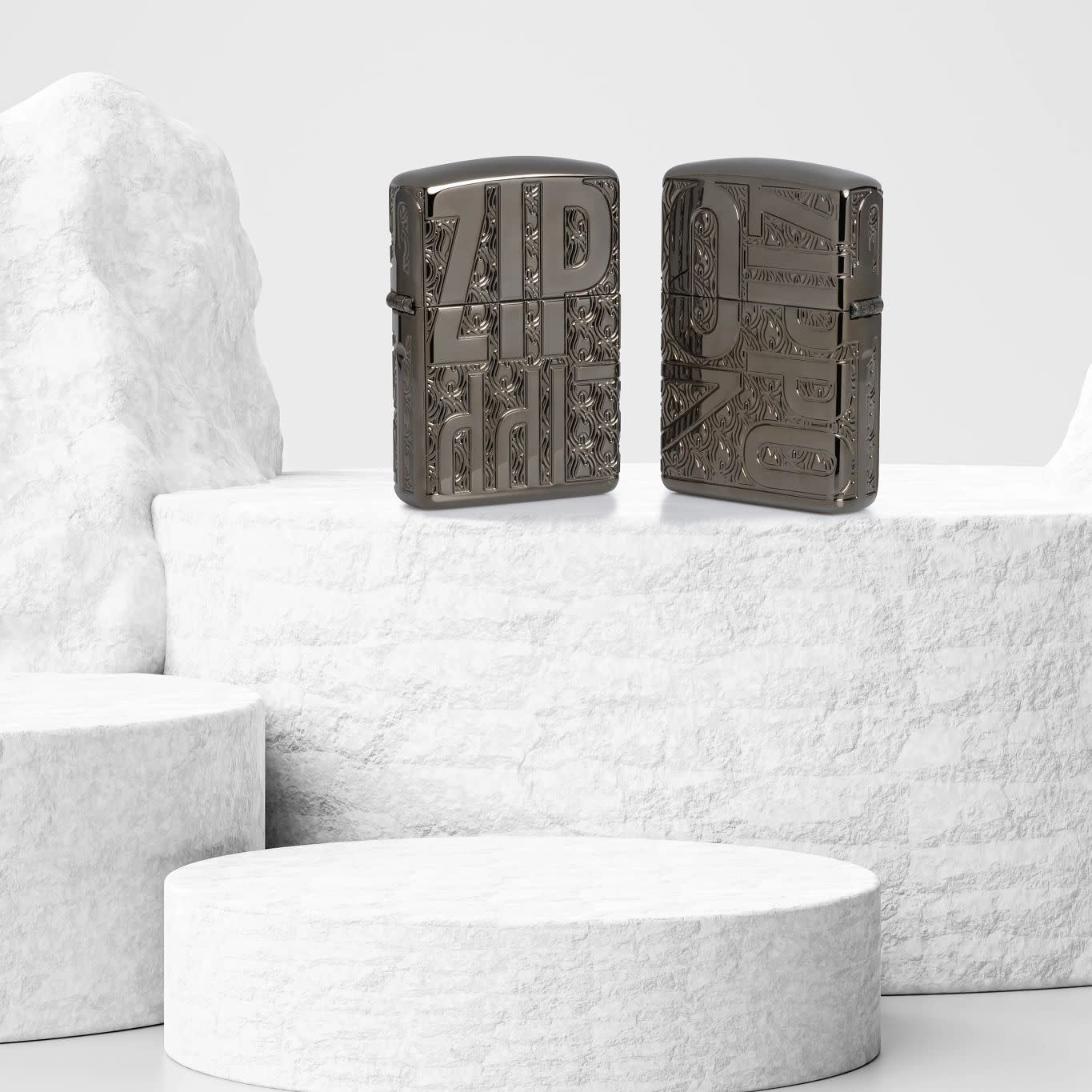 Lifestyle image of two Zippo Reverse Carve Zippo Design Armor?? Black Ice?? Windproof Lighters standing on a white stone cylinder: one showing the front of the lighter, and one showing the back.