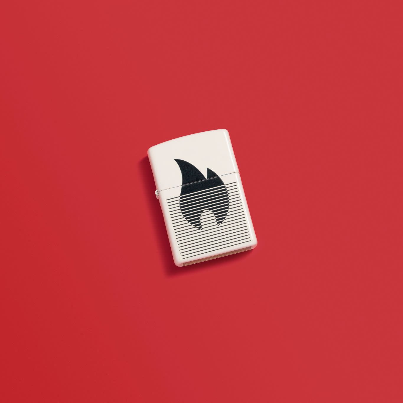 Lifestyle image of Zippo Flame Gradient Design White Matte Windproof Lighter in a red scene.