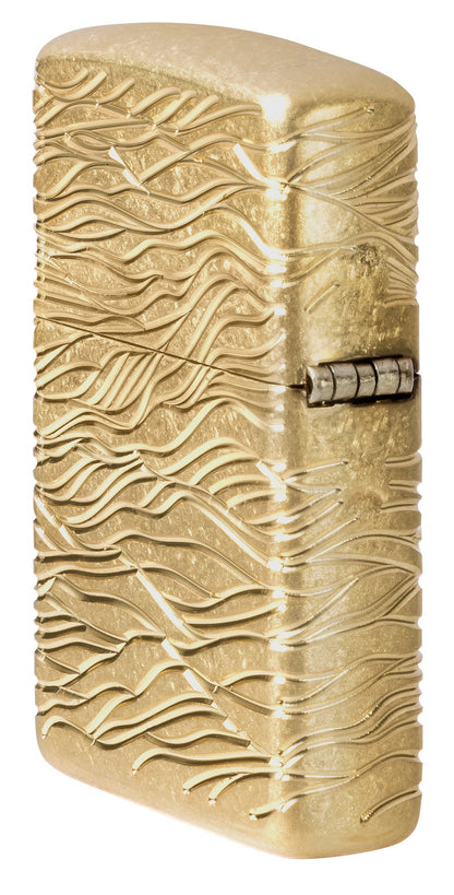 Angled shot of Zippo Luxury Waves Design Armor Tumbled Brass Windproof Lighter showing the back and hinge side of the lighter.